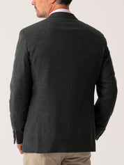 Back view of Olive blazer worn by a man on a light grey background