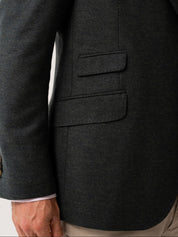 Close-up of a olive blazer with ticket pockets on a white background