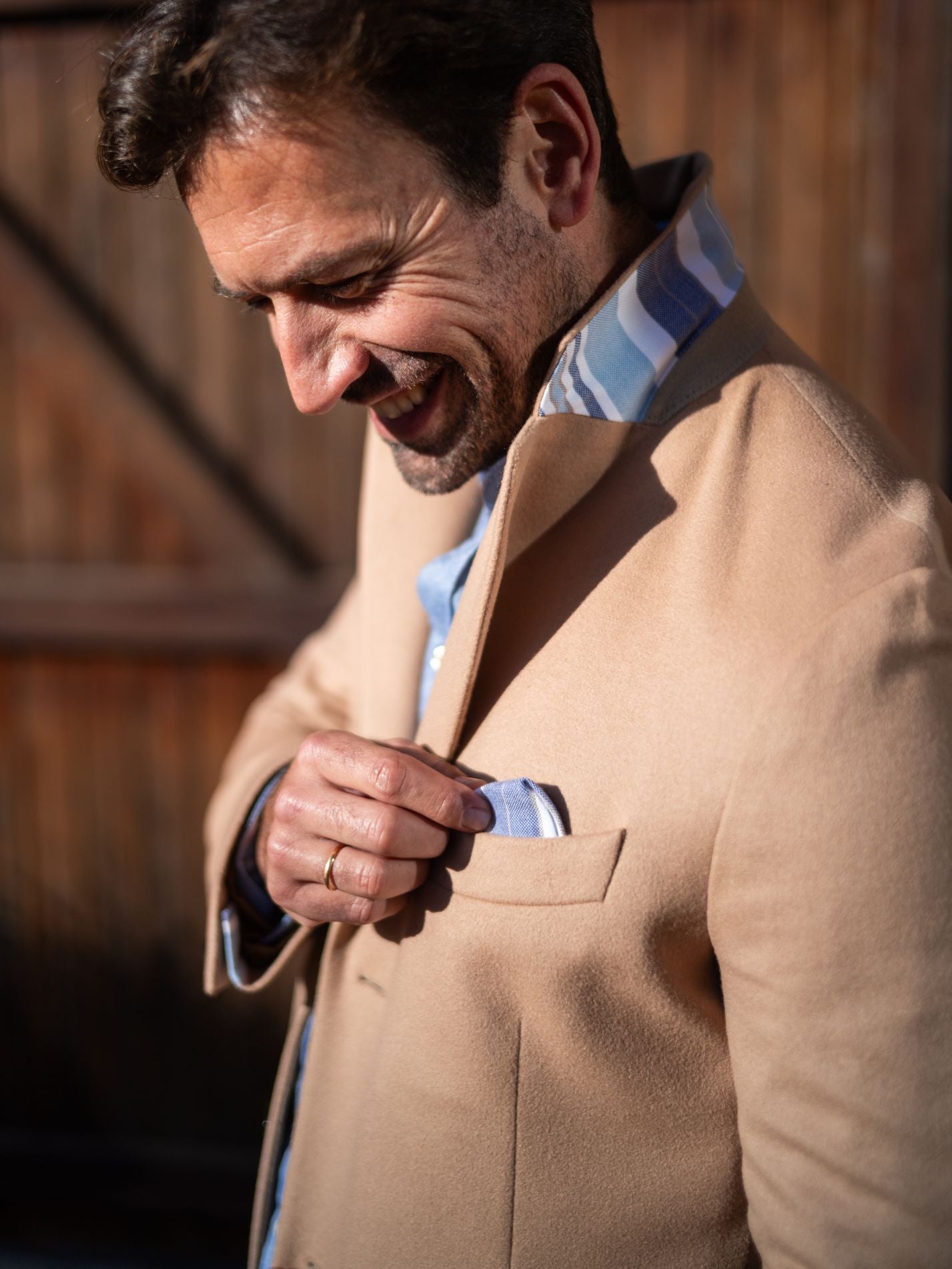 Men’s camel wool overcoat with colourful detailing under the collar.