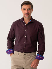 Man wearing a dark Burgundy Cotton-Cashmere shirt with rolled-up sleeves on a white background