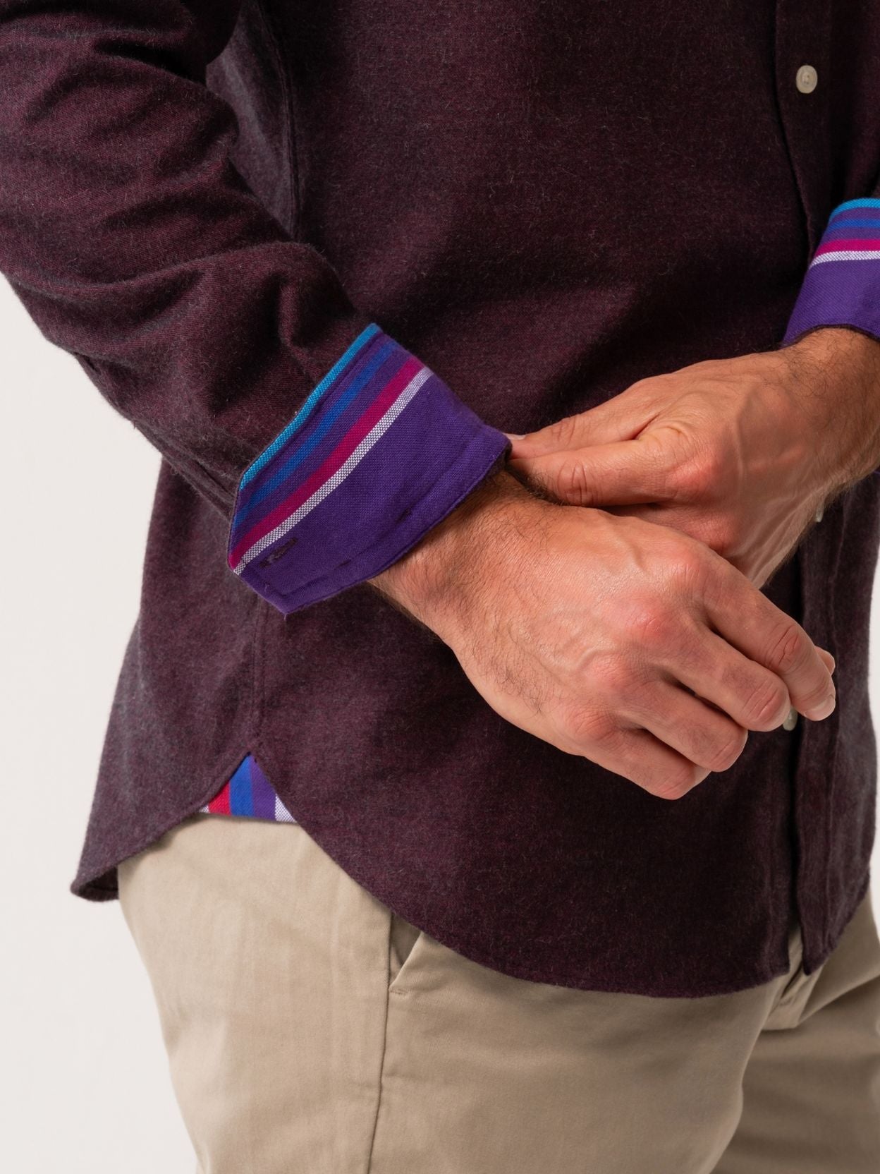 Person wearing a dark Burgundy Cotton-Cashmere shirt with colourful cuffs on a white background