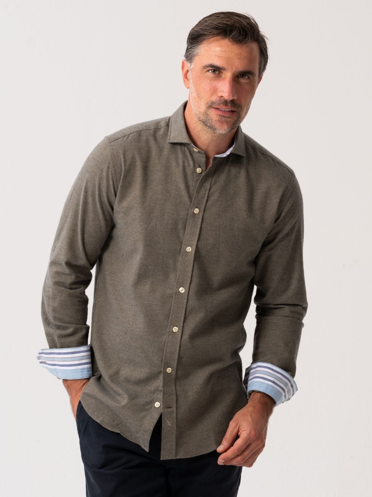 Man wearing an Olive Cotton-Cashmere Shirt with striped cuffs on a white background