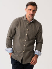 Man wearing an Olive Cotton-Cashmere Shirt with striped cuffs on a white background
