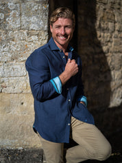 Man wearing a navy basketweave shirt with blue trim