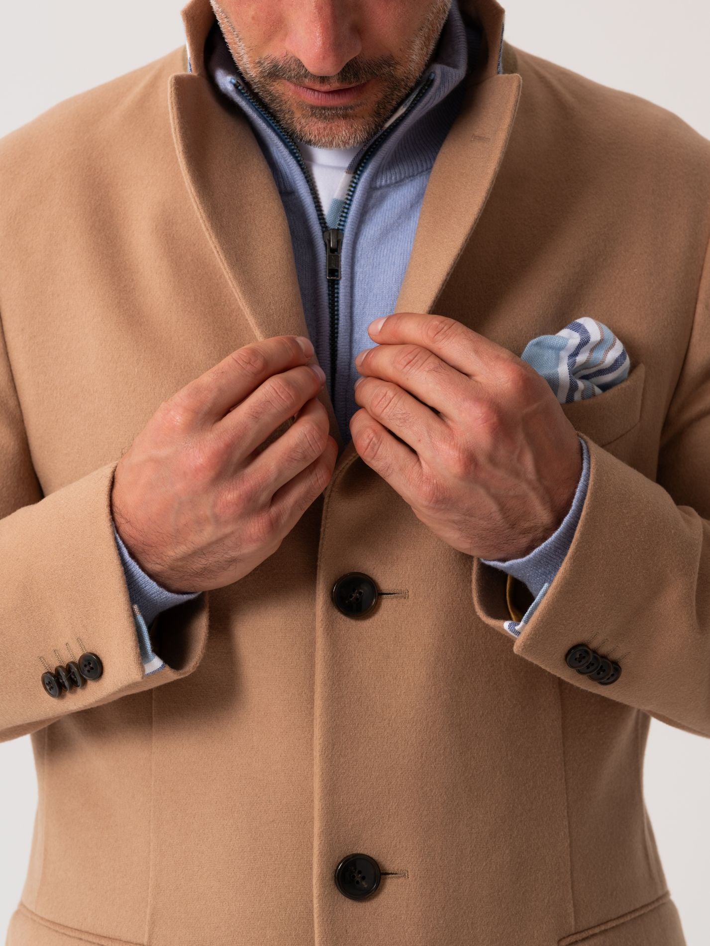 Close-up of notch lapel on camel wool overcoat