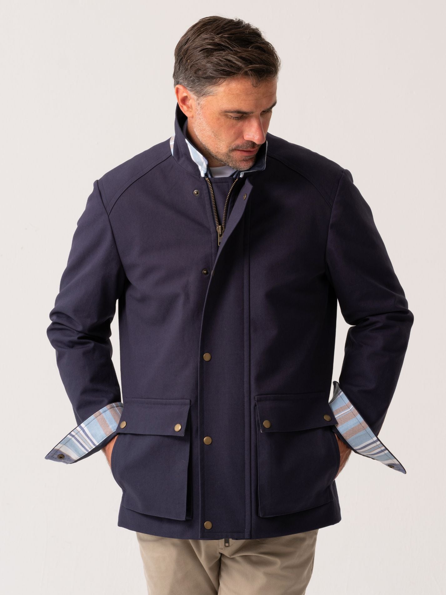 Mens navy outerwear coat with water resistant finish - front view on plain background 