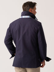 Mens navy outerwear coat with water resistant finish - back view on plain background 