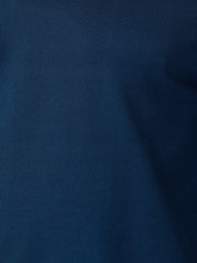 A close-up of dark navy blue fabric with a fine woven texture and soft folds.