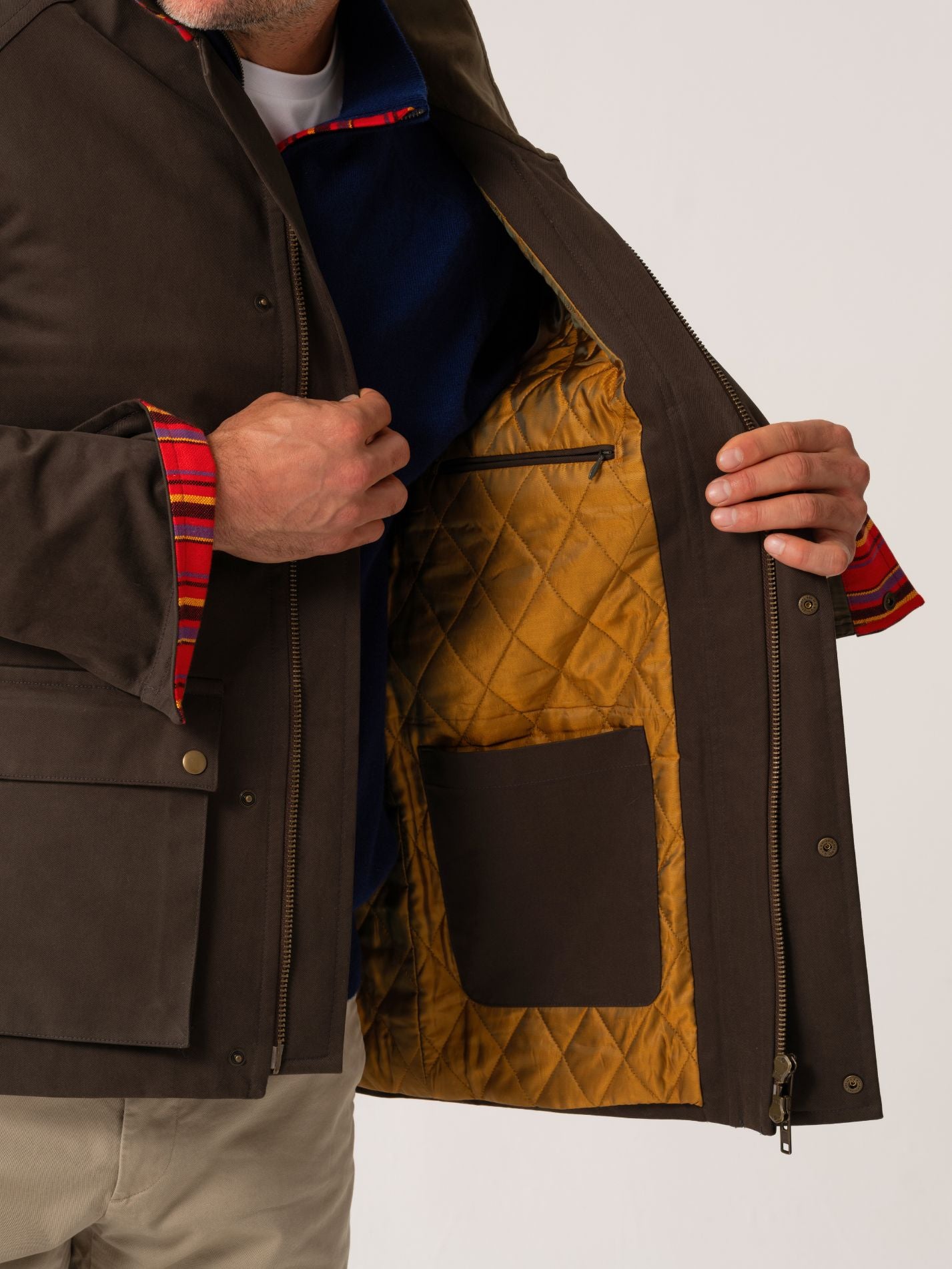 Mens outerwear coat in Dark Olive with gold quilted inner layer