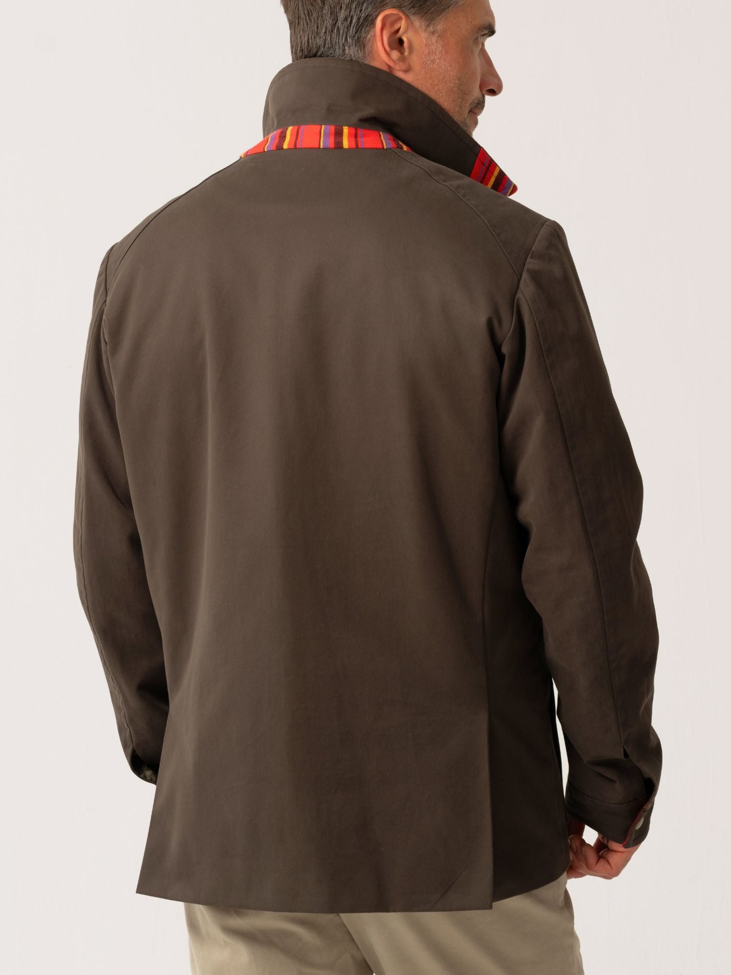 Mens outerwear coat in Dark Olive with African fabric detail - back view on plain background 