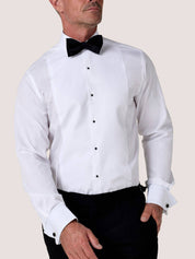 Koy white dress shirt styled with a black bow tie done up and jet shirt studs, hand resting in trouser pocket