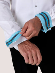 Close-up of the Koy dress shirt cuff turned back to reveal its blue striped Kikoy lining and black cufflink