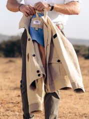 The Ranger Jacket by Koy Clothing. This is a beige bomber jacket with blue and white mottled Kenyan Kikoy fabric trim.
